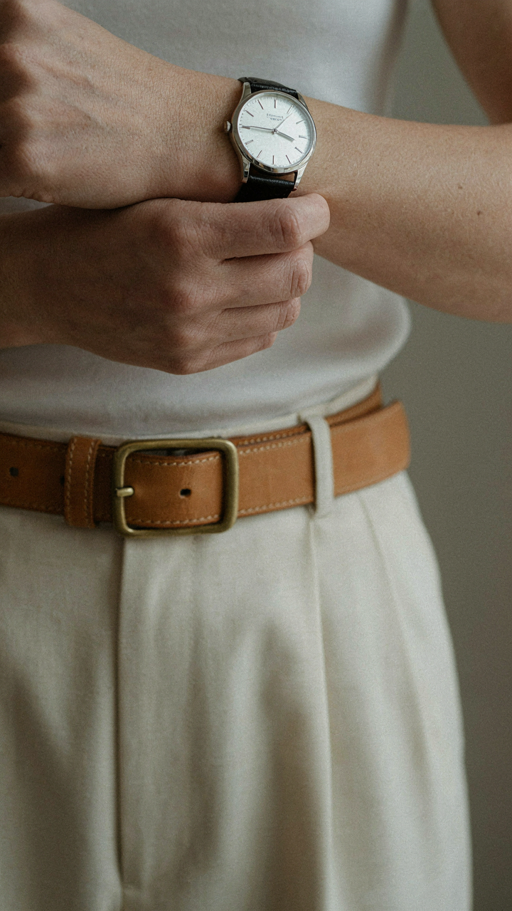 Classic leather belt with a buckle cinched on wide leg pants.