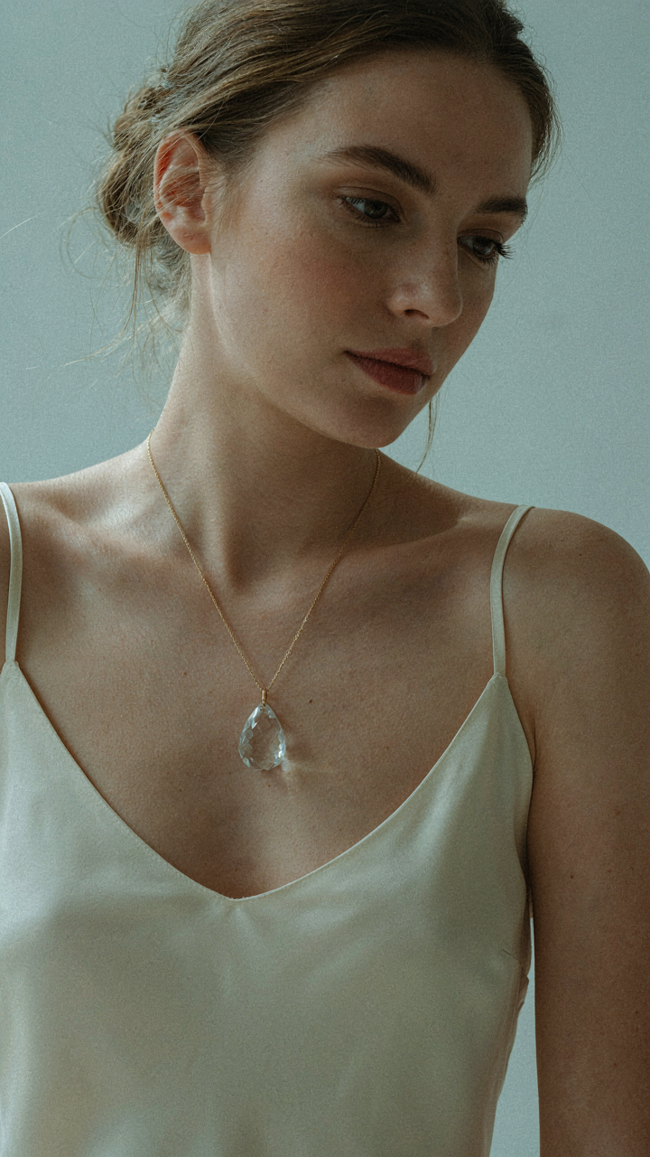 A single statement necklace with a large pendant rests on a surface.