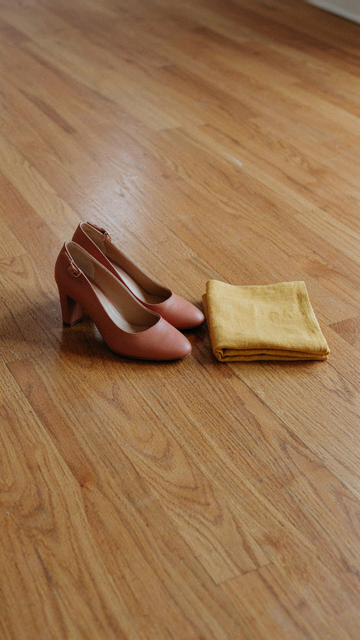 Muted terracotta pumps sit beside a swatch of butter yellow fabric.