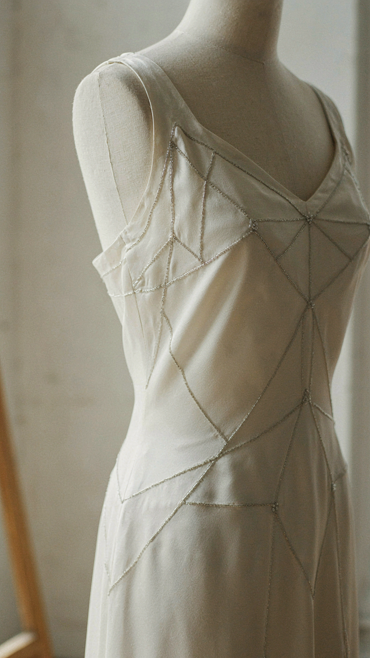 Geometric beading traces lines on a vintage bias-cut gown.