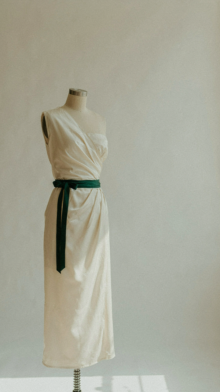 Tailor's dummy draped with a wrap dress and an asymmetrical neckline.