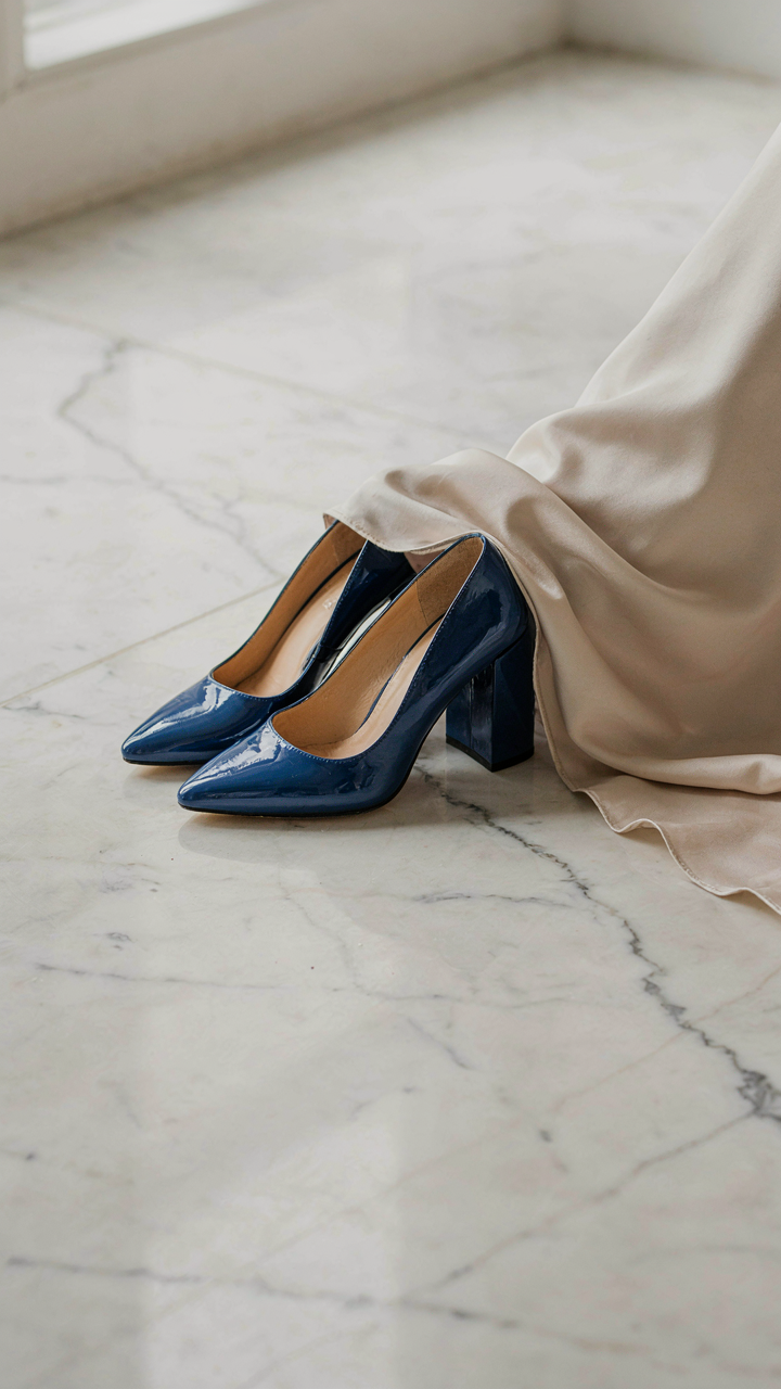 Sapphire blue block heels provide visual weight under a flowing gown.