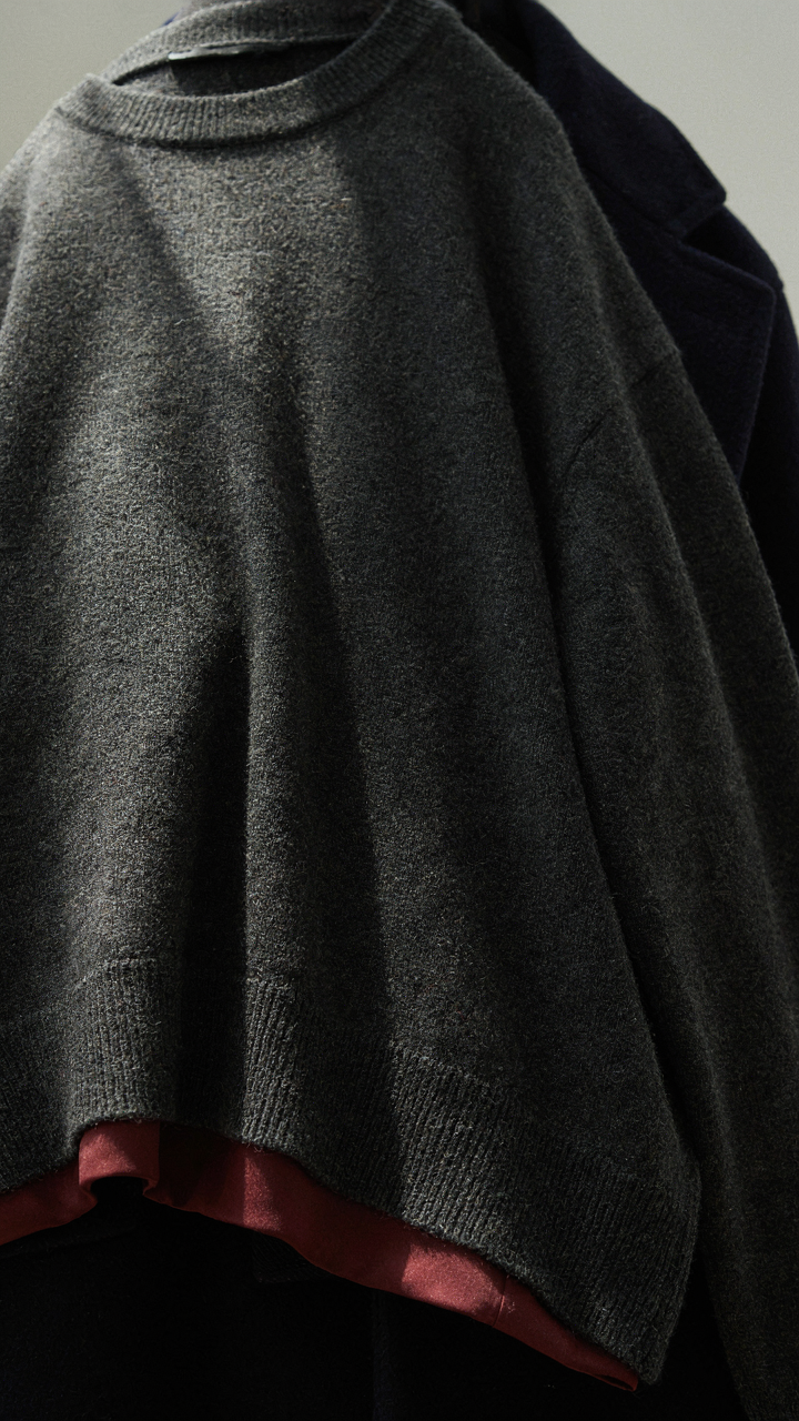 Close-up of charcoal, burgundy, and navy fabrics showing layered textures.