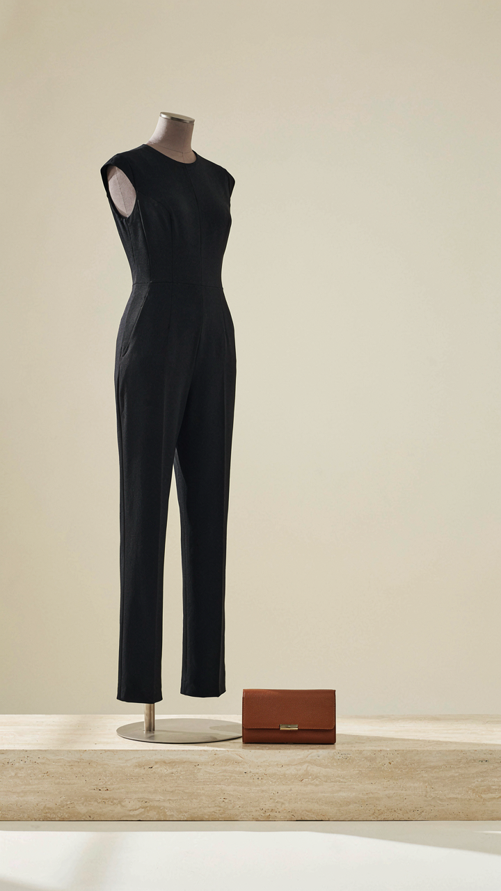 A chic, tailored jumpsuit and a simple clutch, suitable for a graduation dinner dress.
