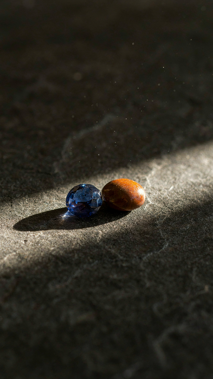Sapphire and rust stones glow under a warm autumn sunbeam.