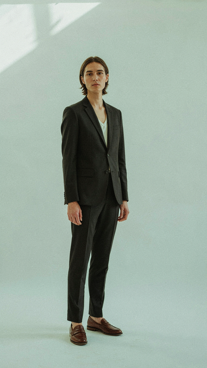 A person with excellent posture and neat grooming wears a well-fitted blazer.
