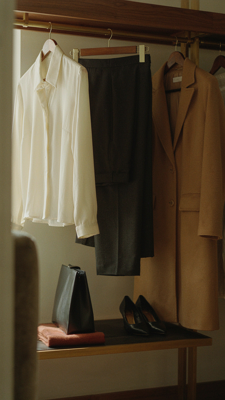 A well-organized closet with timeless clothing pieces for a Broadway show.