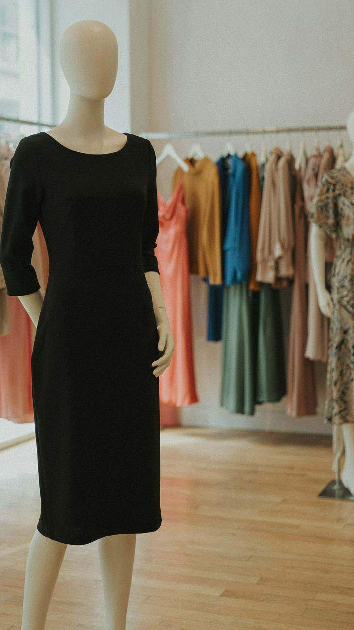A classic black dress stands out among brightly colored clothes.