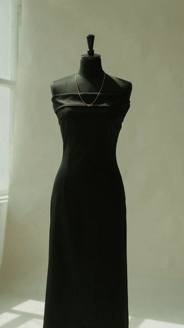 Black off shoulder dress with one delicate gold chain necklace.