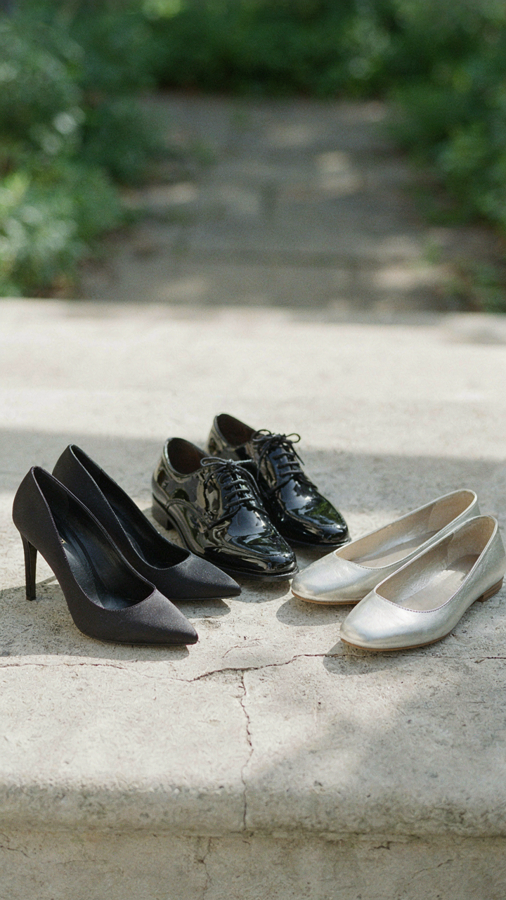 Three pairs of diverse formal black shoes, including pumps, oxfords, and flats.