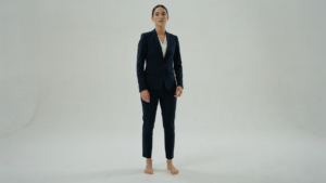 A petite woman in a perfectly tailored navy pantsuit, showcasing ideal fit.