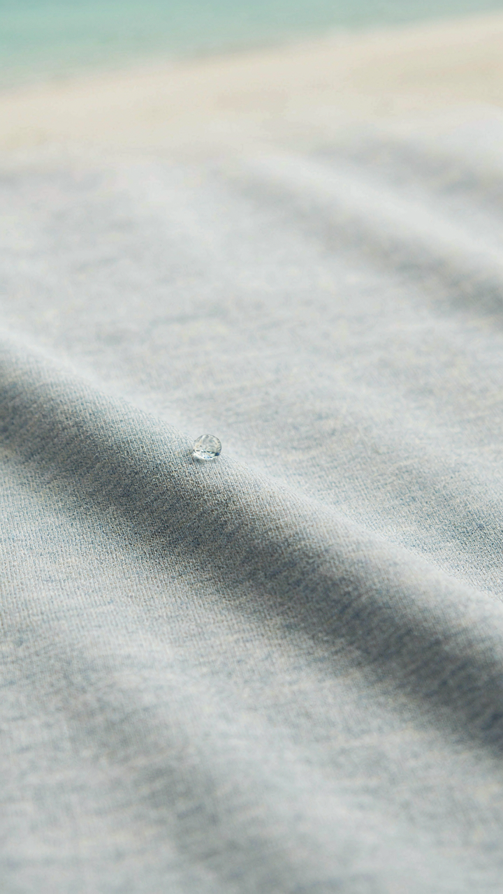 A close-up of a lightweight, moisture-wicking synthetic fabric shirt.