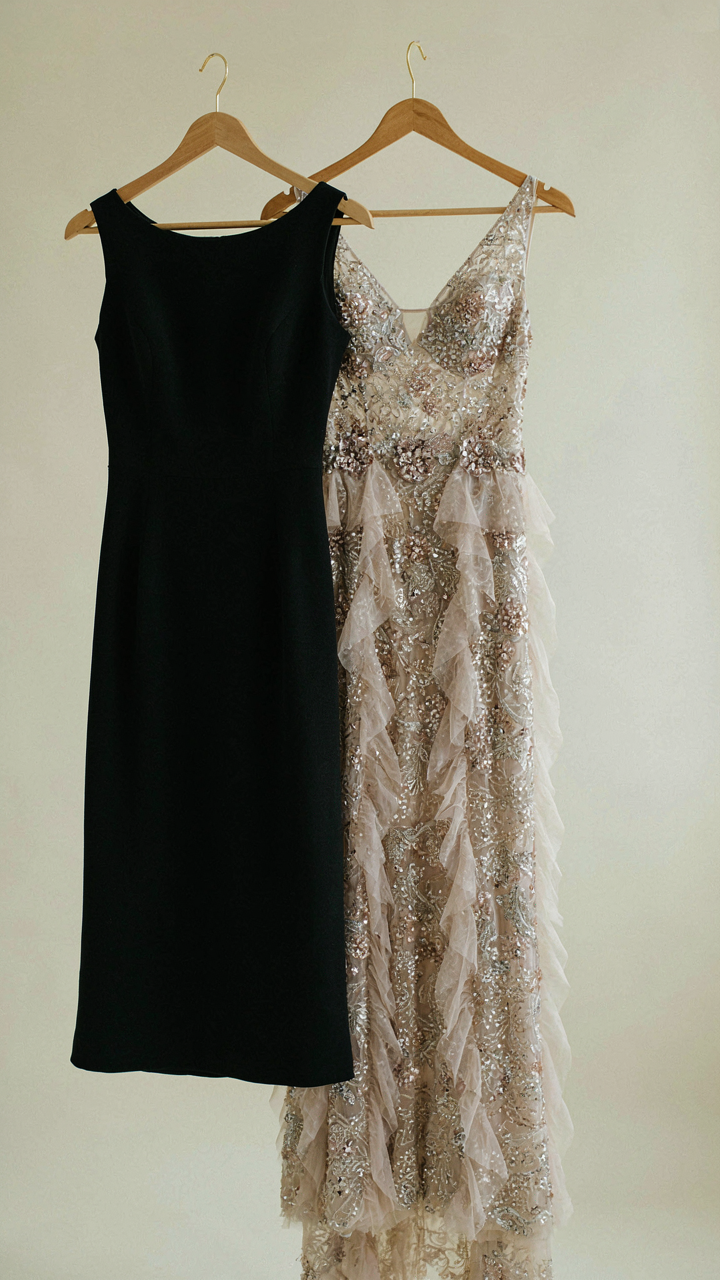 A tailored black wool dress next to an embellished, sequined dress.