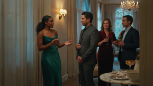 People in stylish cocktail hour outfits mingle at an elegant evening party.