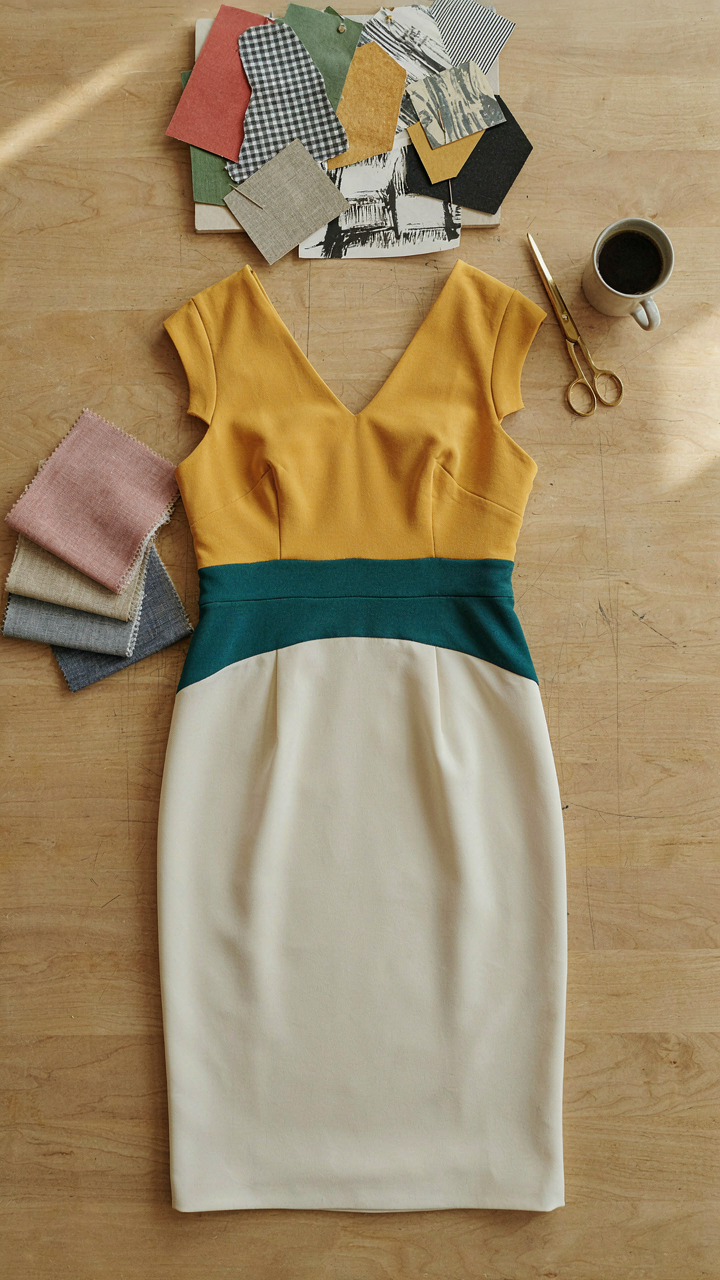 A wrap cocktail dress with color blocks on a graphic designer's desk.