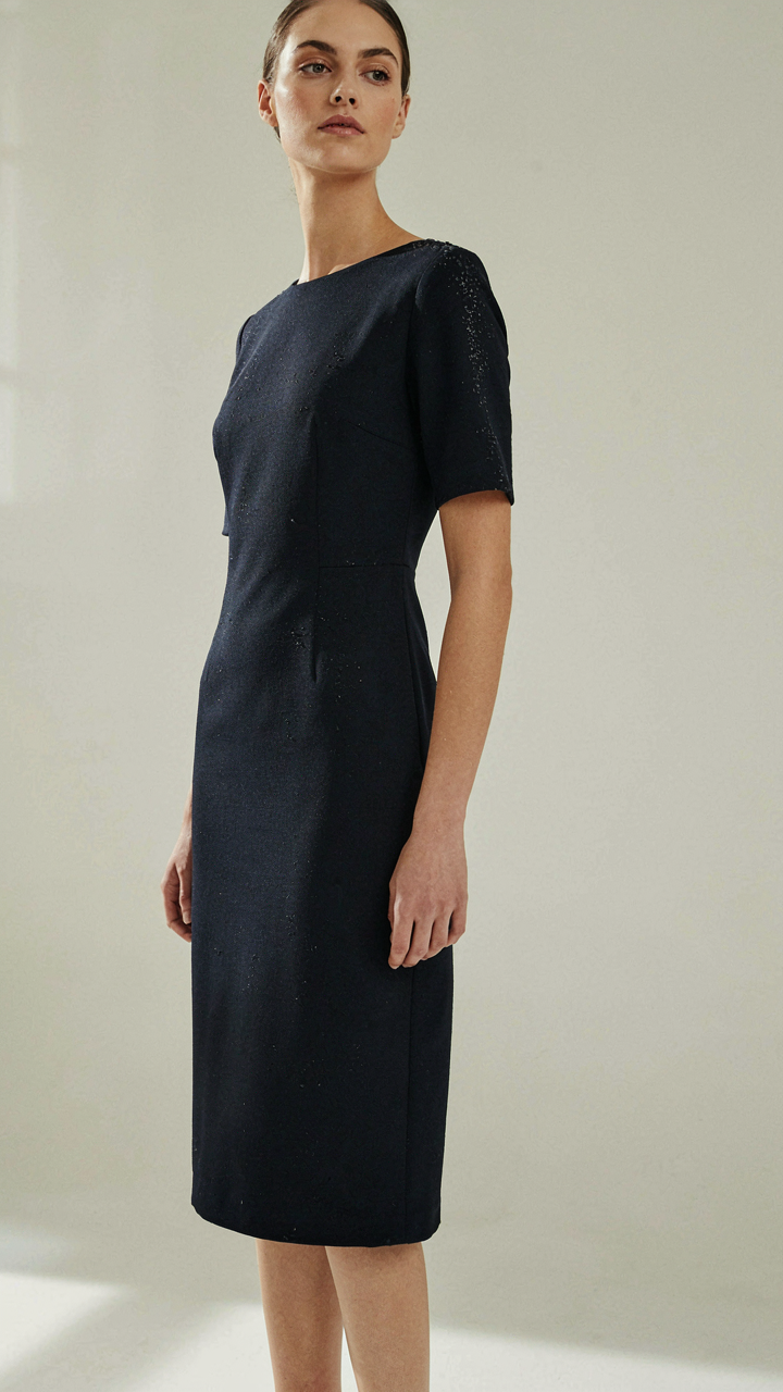 Small water droplets bead on a dark navy midi dress, hiding wet spots.