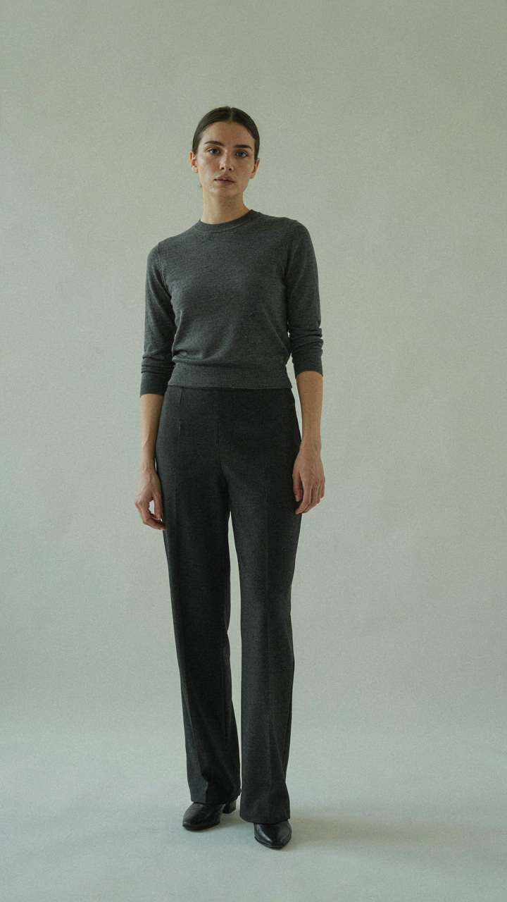 A petite woman in a monochromatic dark gray outfit, showing vertical continuity.