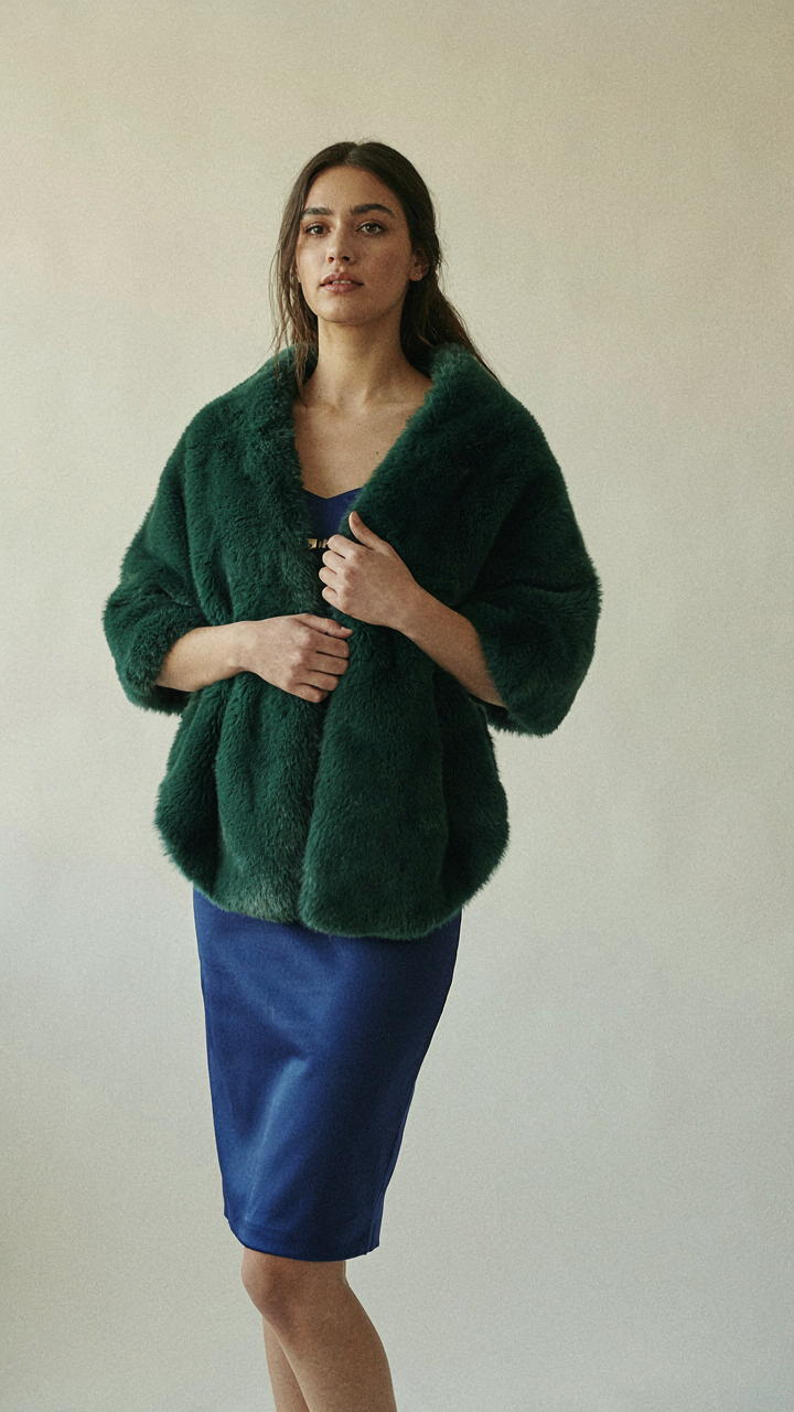 Deep emerald faux fur wrap paired with a rich sapphire blue dress.