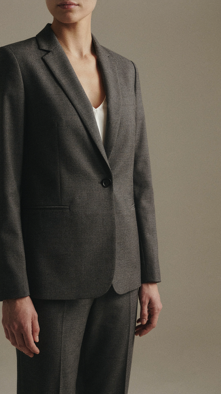 Close-up of a well-fitted blazer on a woman, showing crisp lines.