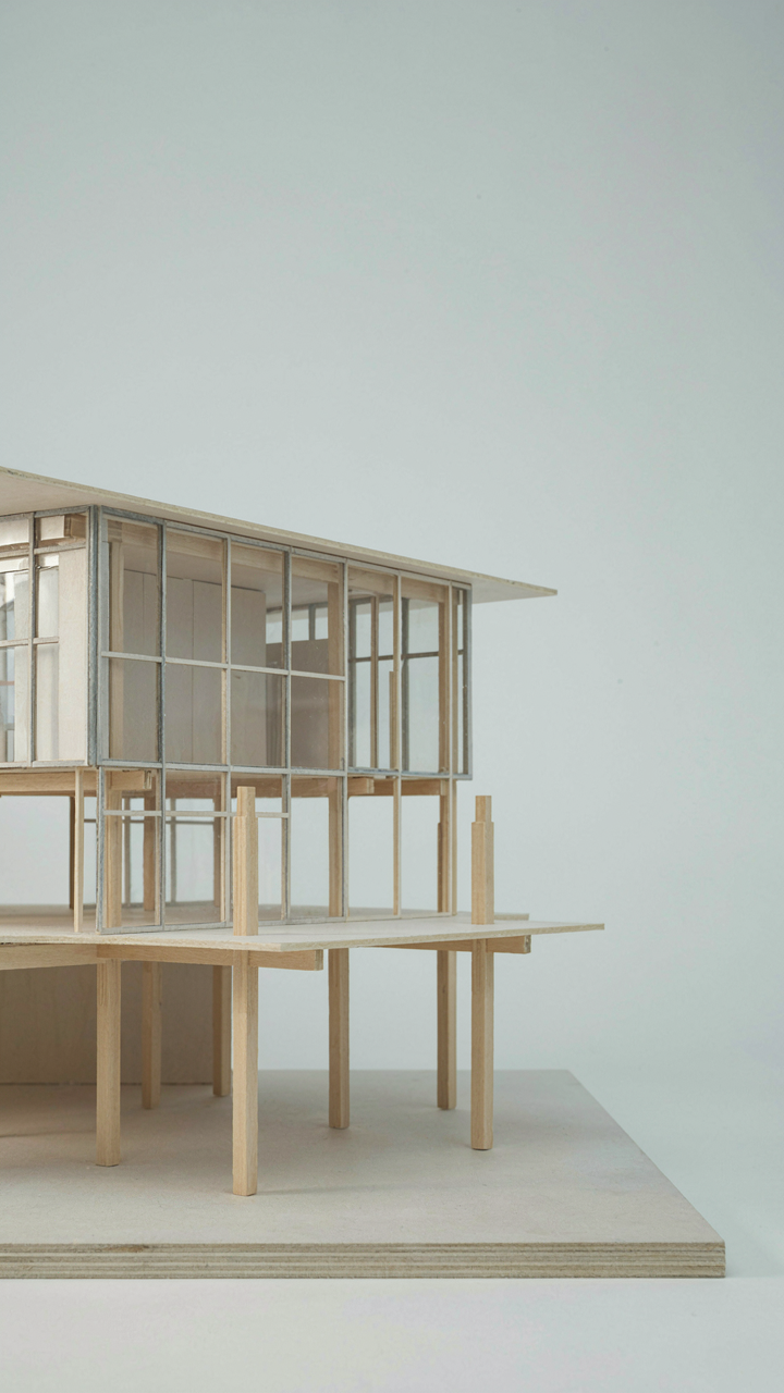 An architectural model shows columns supporting a light building.