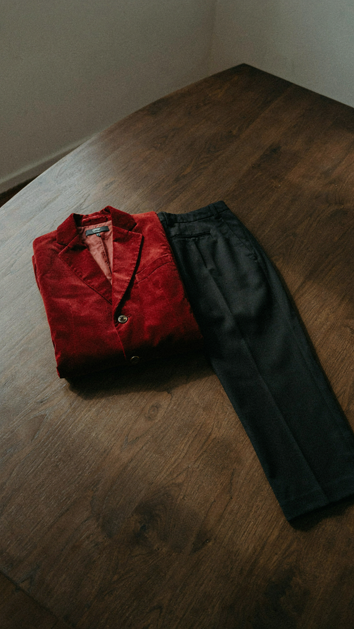 A crimson velvet jacket and black trousers. A festive attire dress code.