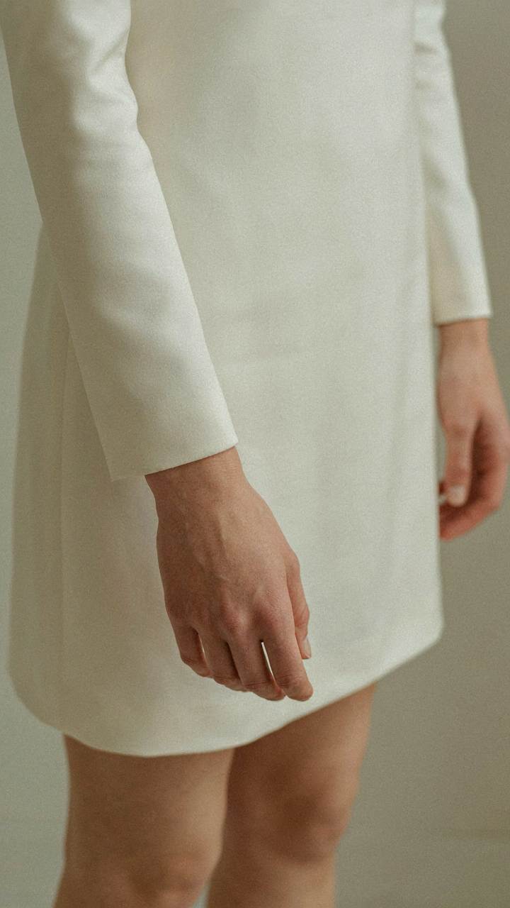A close-up of a tailored long sleeve with a tapered cuff.