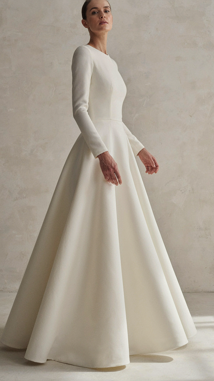 A woman in a fitted bodice and a long, structured A-line skirt.
