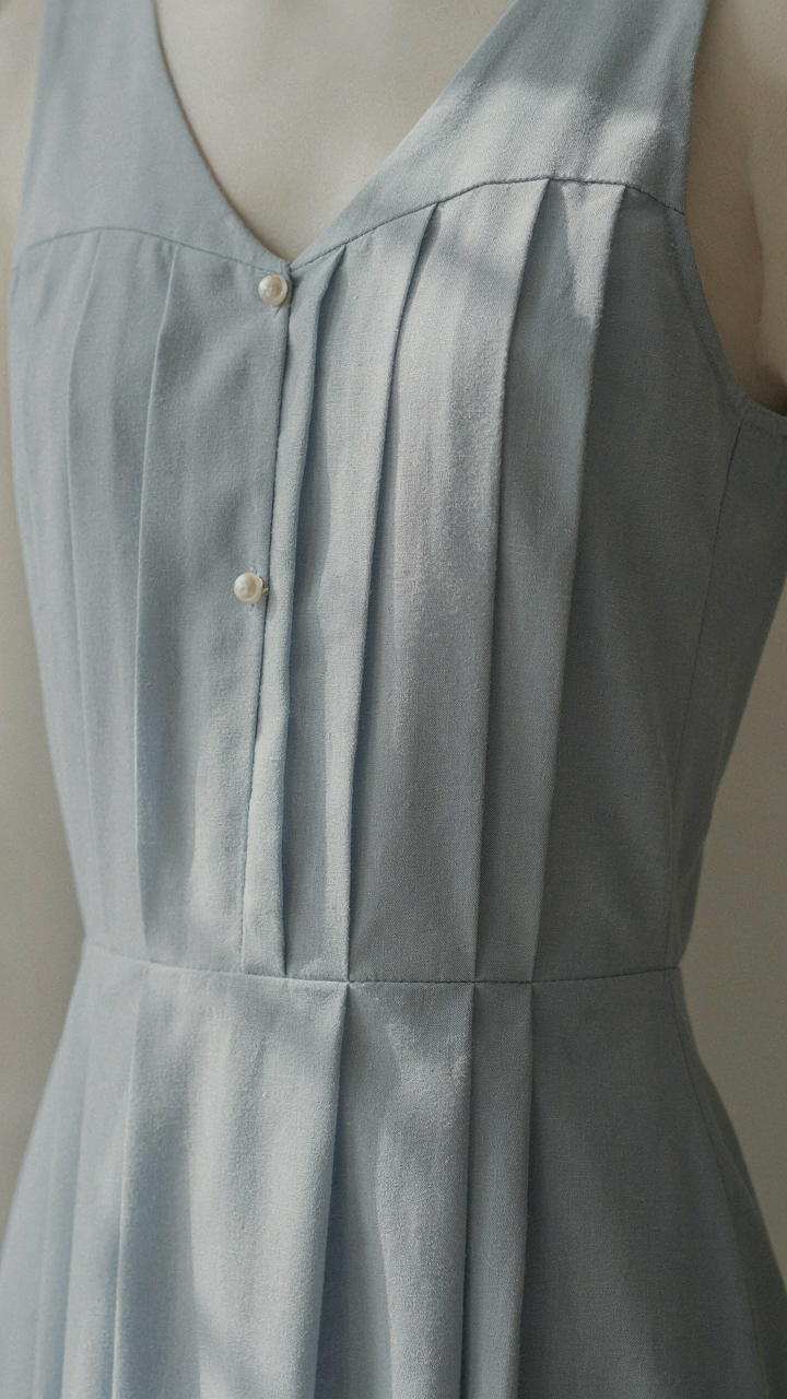A close-up of a structured cotton blend fabric in a dress, holding its shape.