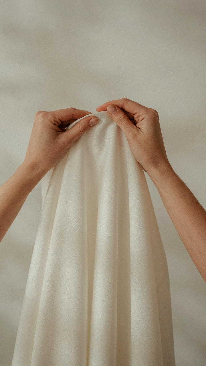A close-up view of a shimmering silk crepe fabric sample.