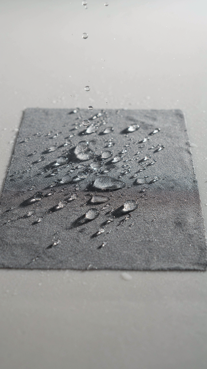 Close-up of a synthetic fabric showing its weave and water repellency.