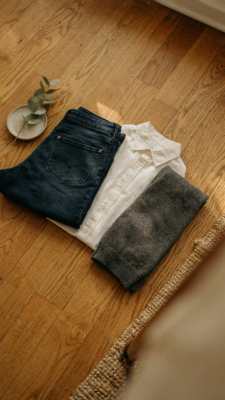 Clean dark jeans, a pressed shirt, and a dark sweater for a family gathering.