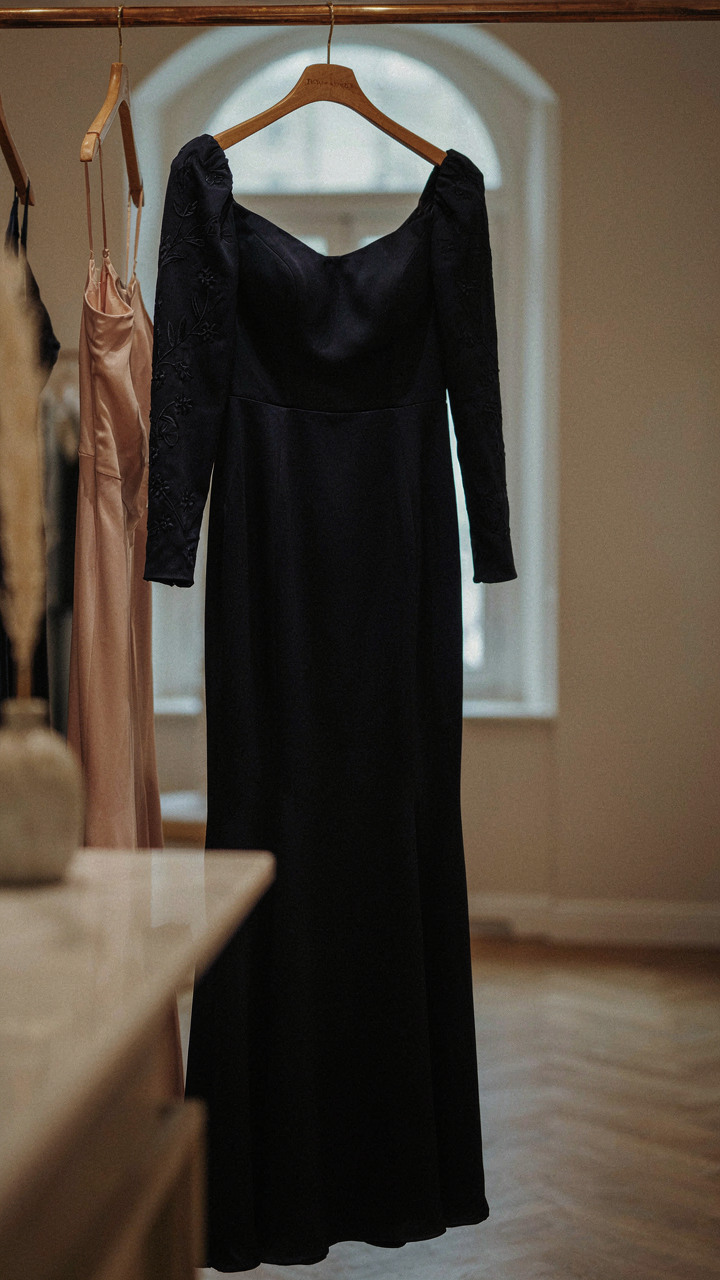 A tailored cocktail dress with a custom embroidered detail.