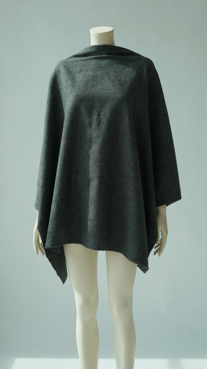 Close-up of heavy wool fabric on a mannequin, showing texture.