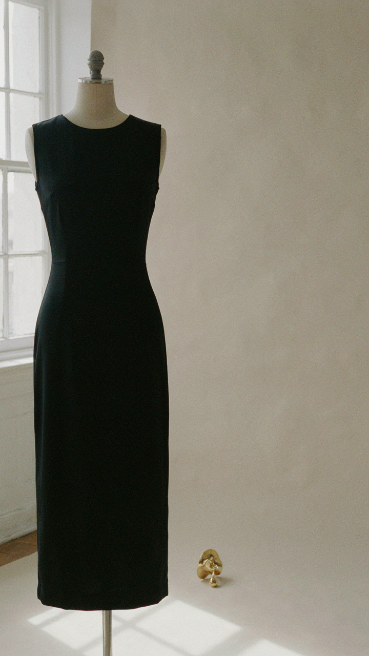 A perfectly cut black dress with one statement earring.
