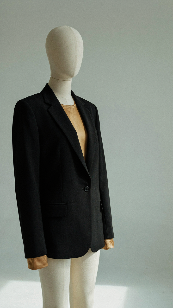 Gold top intentionally paired with a structured black blazer.