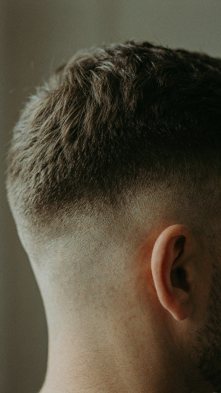 A close-up of a neatly styled, precise men's haircut.