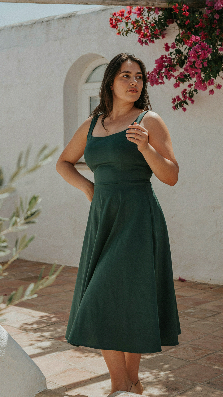 Curvy woman in a well-fitted midi dress, showing the hemline.
