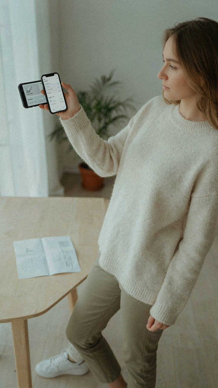 A smartphone screen shows a flight itinerary with a small paper backup.