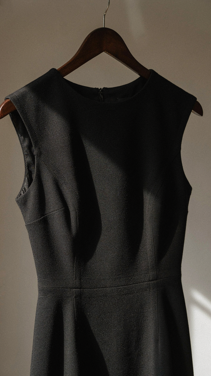 Close-up of a high-quality wool crepe dress with visible, precise stitching.