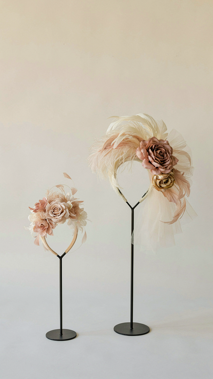 A small, discreet fascinator next to a large, dramatic fascinator.