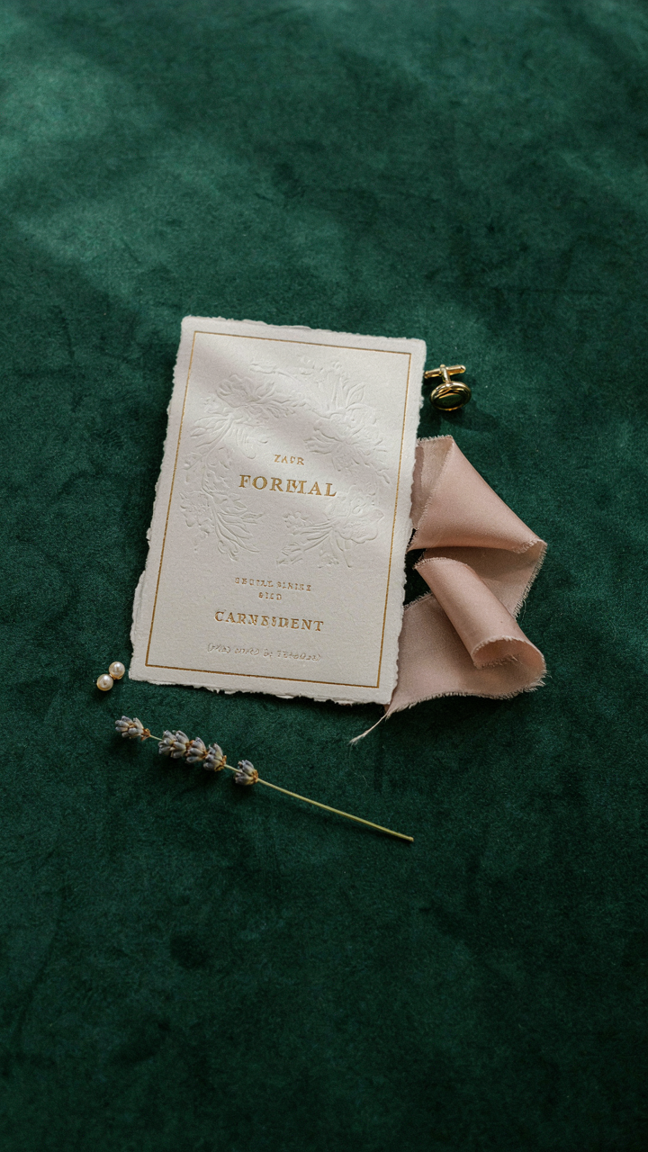 Formal event invitation card on velvet with subtle dress code clues.