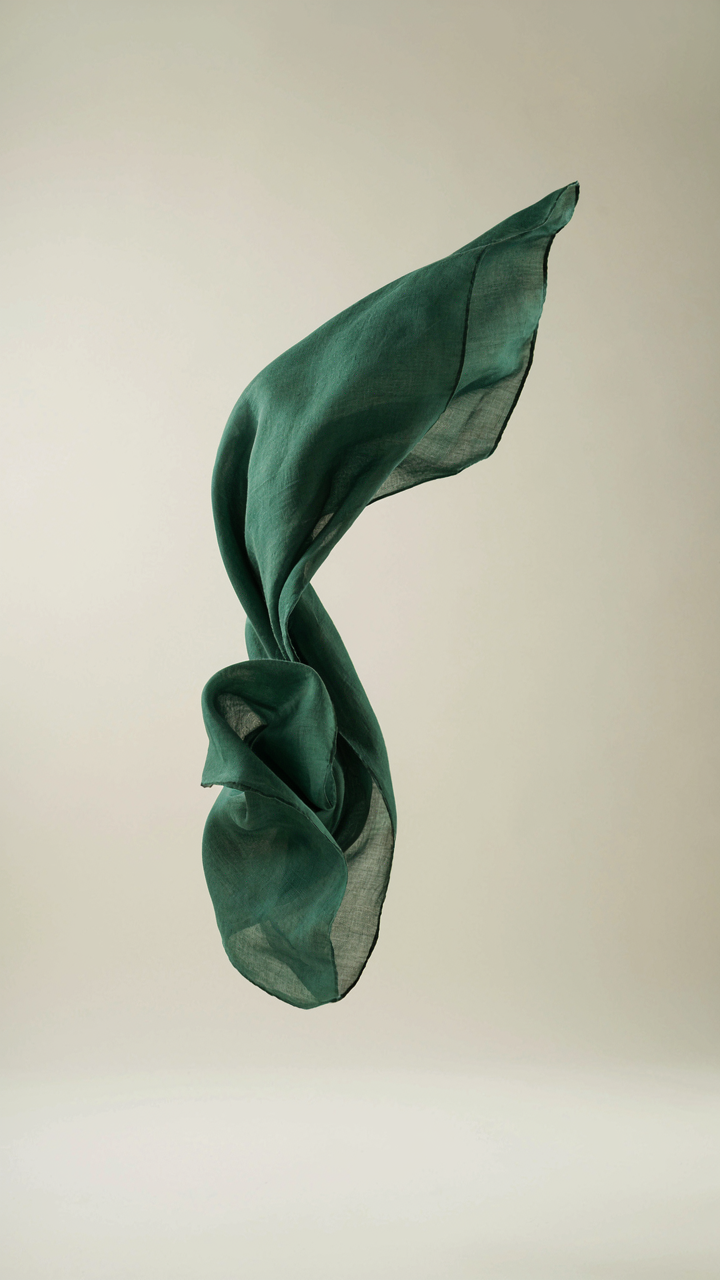 Delicate silk scarf flowing gracefully in a gentle breeze.
