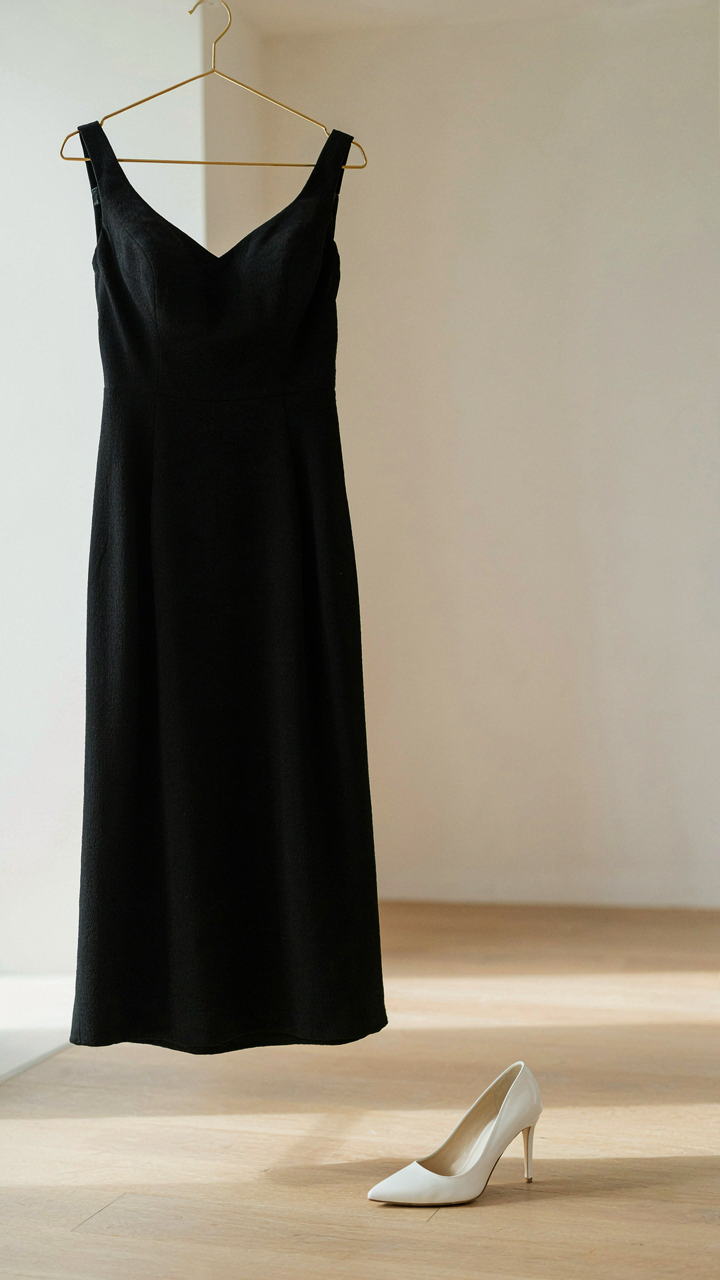 A black cocktail dress paired with a white shoe, showing outfit balance.