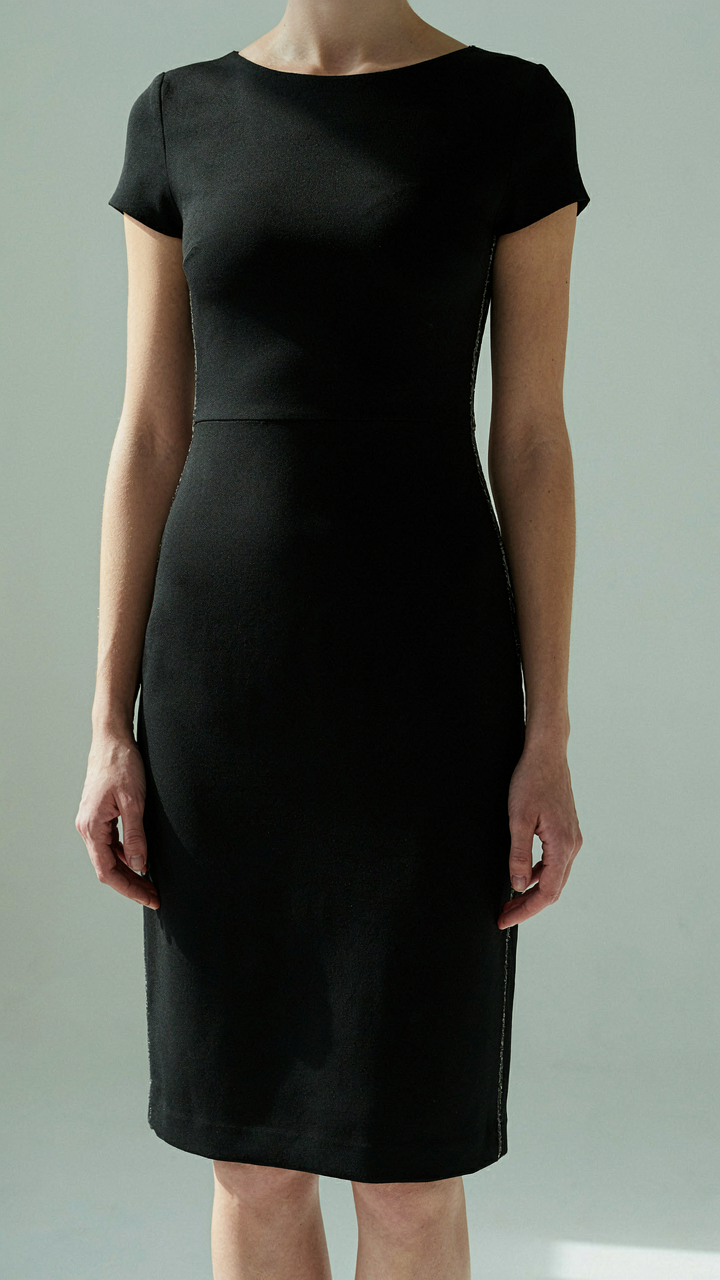 A black dress with metallic threading along the side seam.