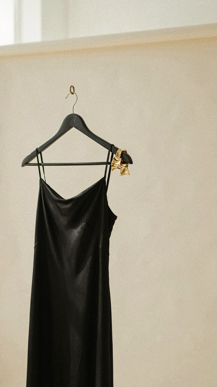 A black dress with one pair of statement earrings.