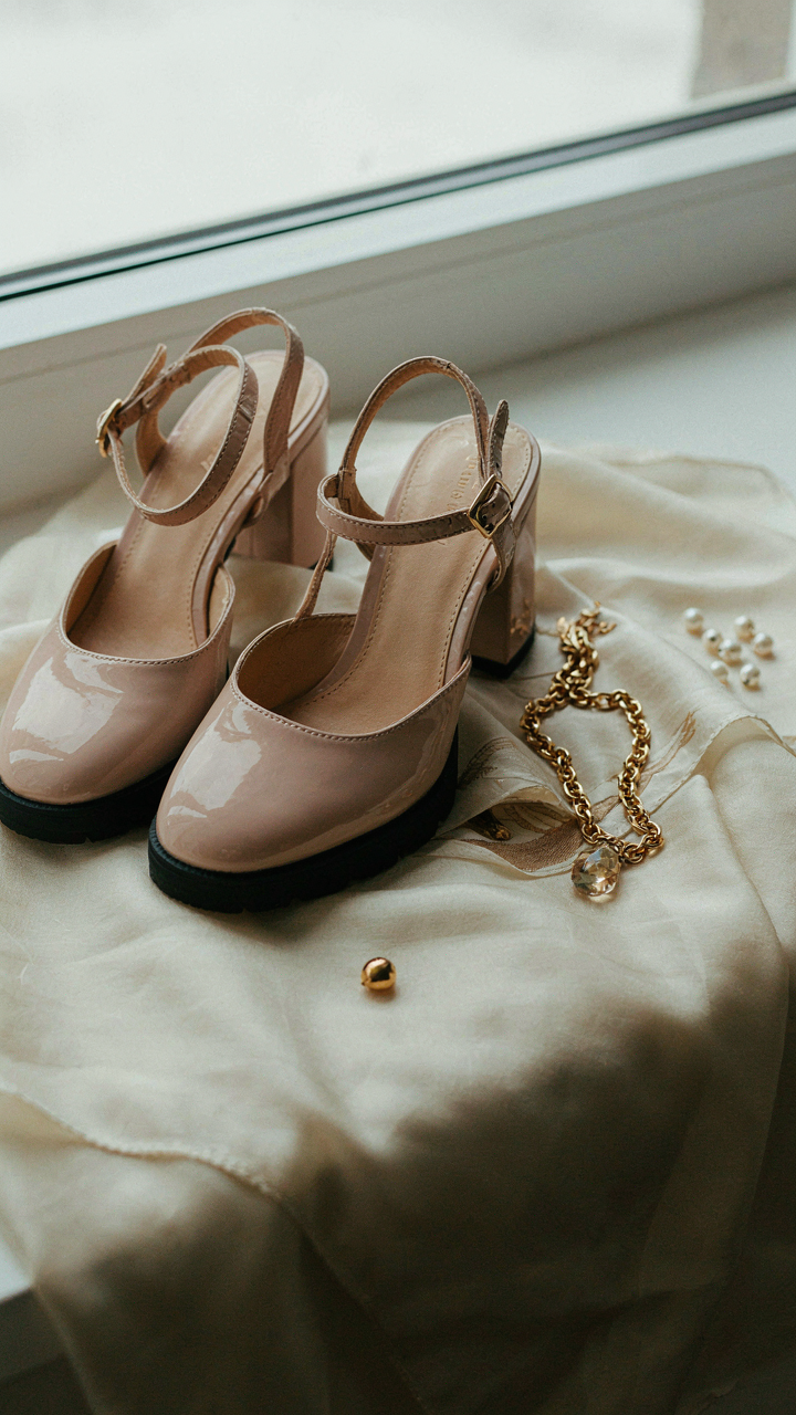 Elegant low block heels, a statement necklace, and a silk scarf.