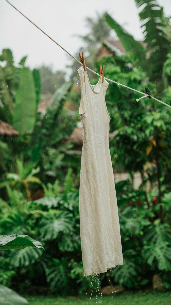 A versatile linen tropical wedding guest dress dries quickly in a tropical rain shower.