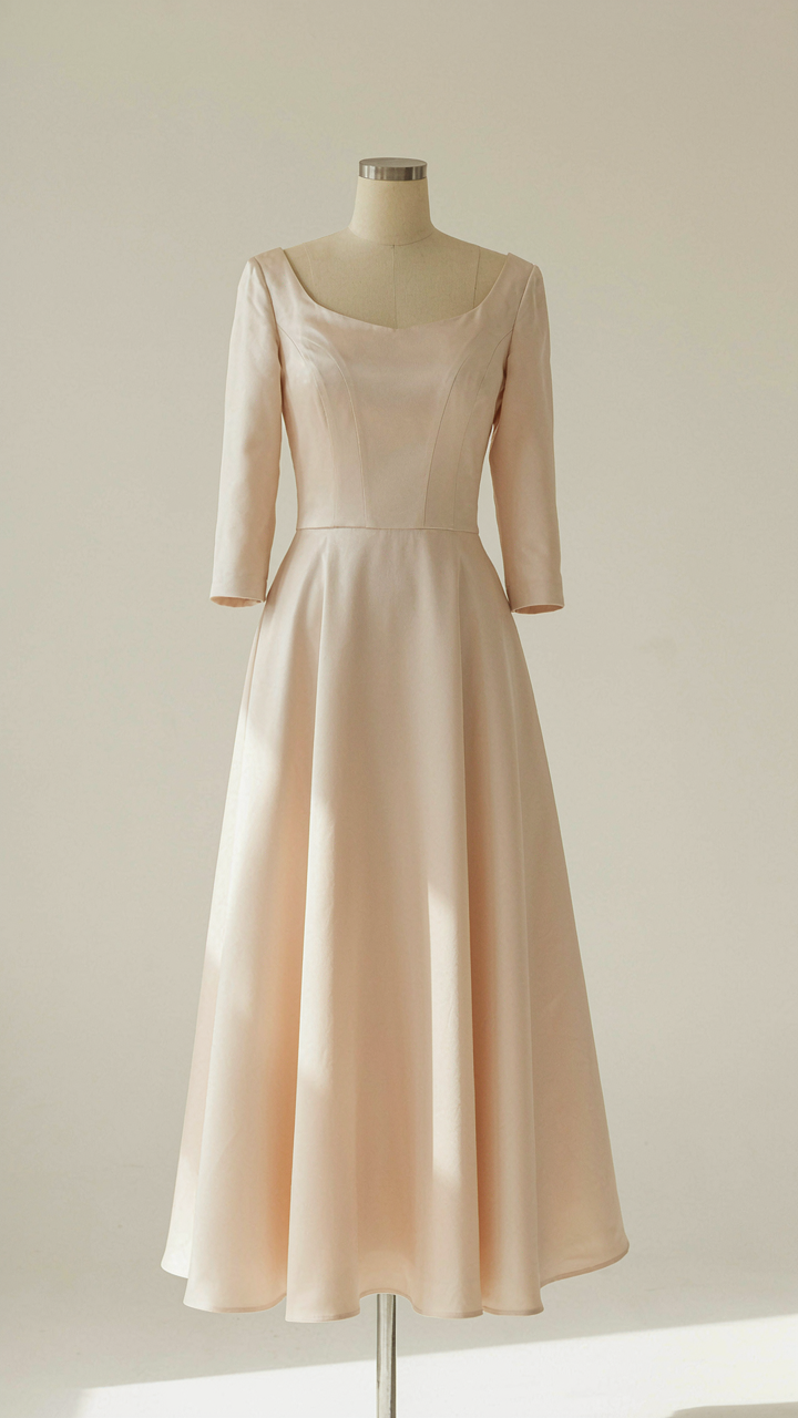 A perfectly shaped A-line october wedding guest dress on a mannequin.