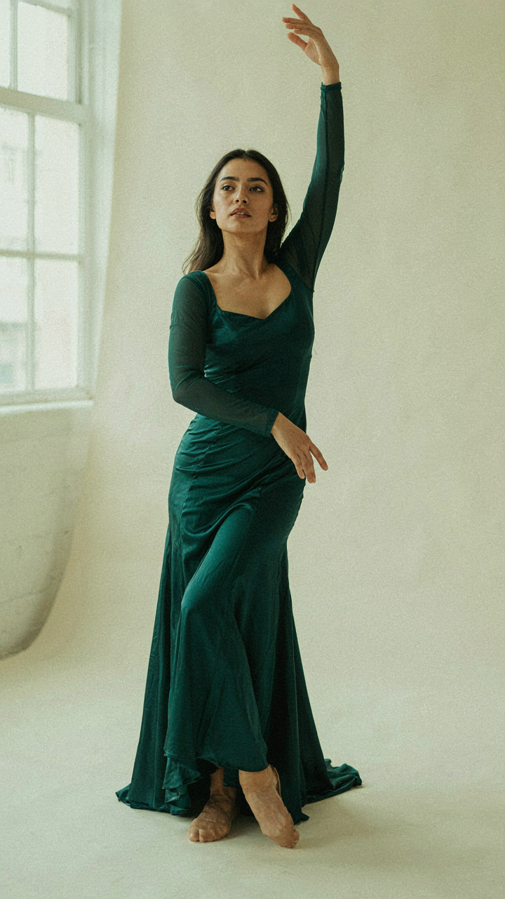A dancer holds a pose with weight on the back leg, creating a subtle S-curve.