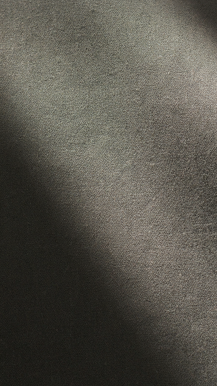 Close-up of a matte crepe pant fabric with a subtle sheen top.